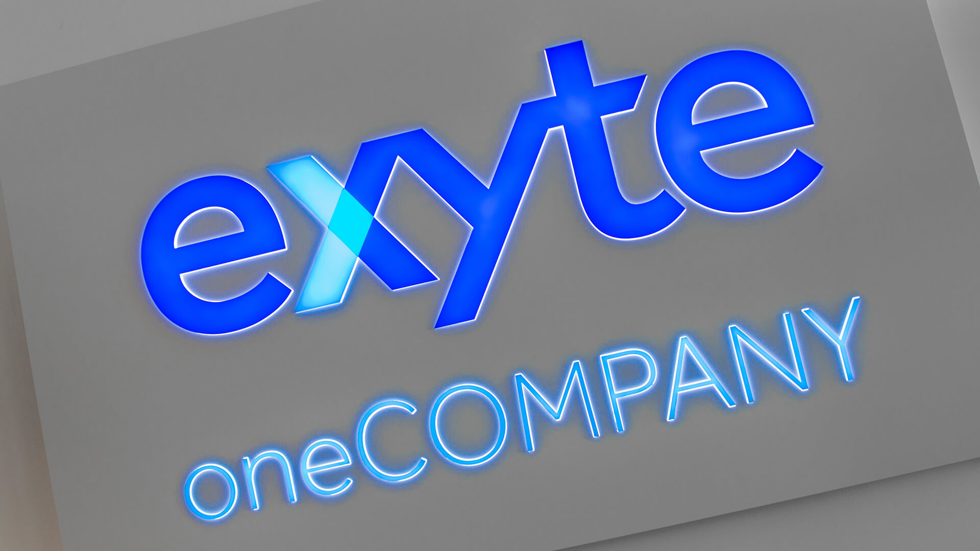 exyte exit exite - exyte-cashonet-on-the-wall-inside-the-office-behind-reception-blue-illuminated-logo-of-the-firm-cashonet-on-order-gdansk-technological-and-scientific-park